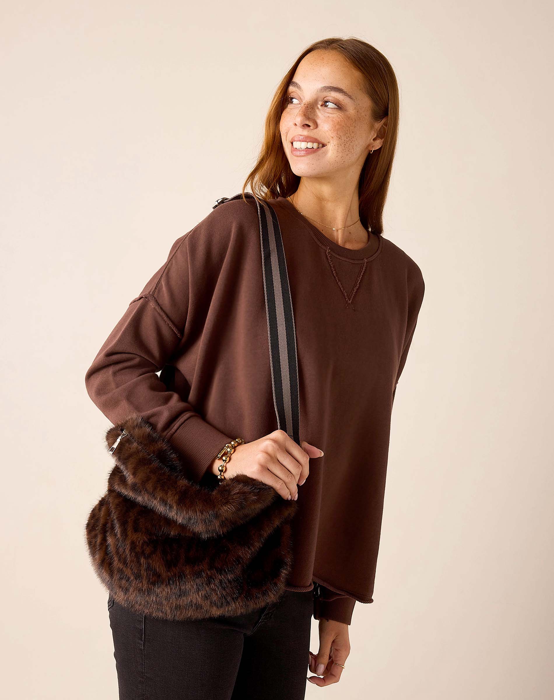 Ladies' travel-ready faux fur crossbody bag in leopard print and brown tones.