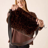 Leopard print faux fur crossbody bag with a wide strap.