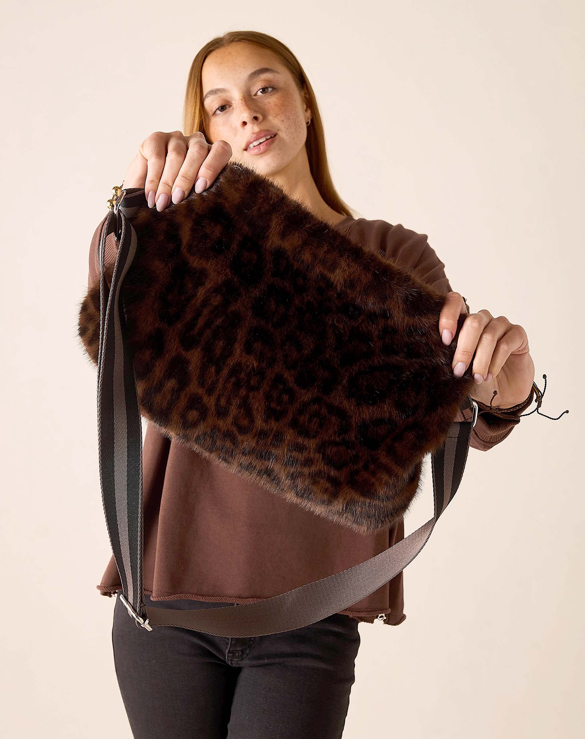 Leopard print faux fur crossbody bag with a wide strap.