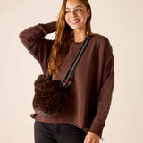 Chocolate brown faux fur crossbody bag with a wide striped strap.
