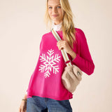 Oatmeal faux fur crossbody bag with a white leather strap and large gold buckle.