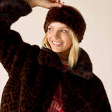 Ladies' travel-ready leopard print faux fur headband in mocha brown.