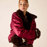 Women's travel-friendly leopard print faux fur mittens in deep berry and brown.