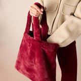 Women's travel-friendly garnet faux fur tote bag with plush handles