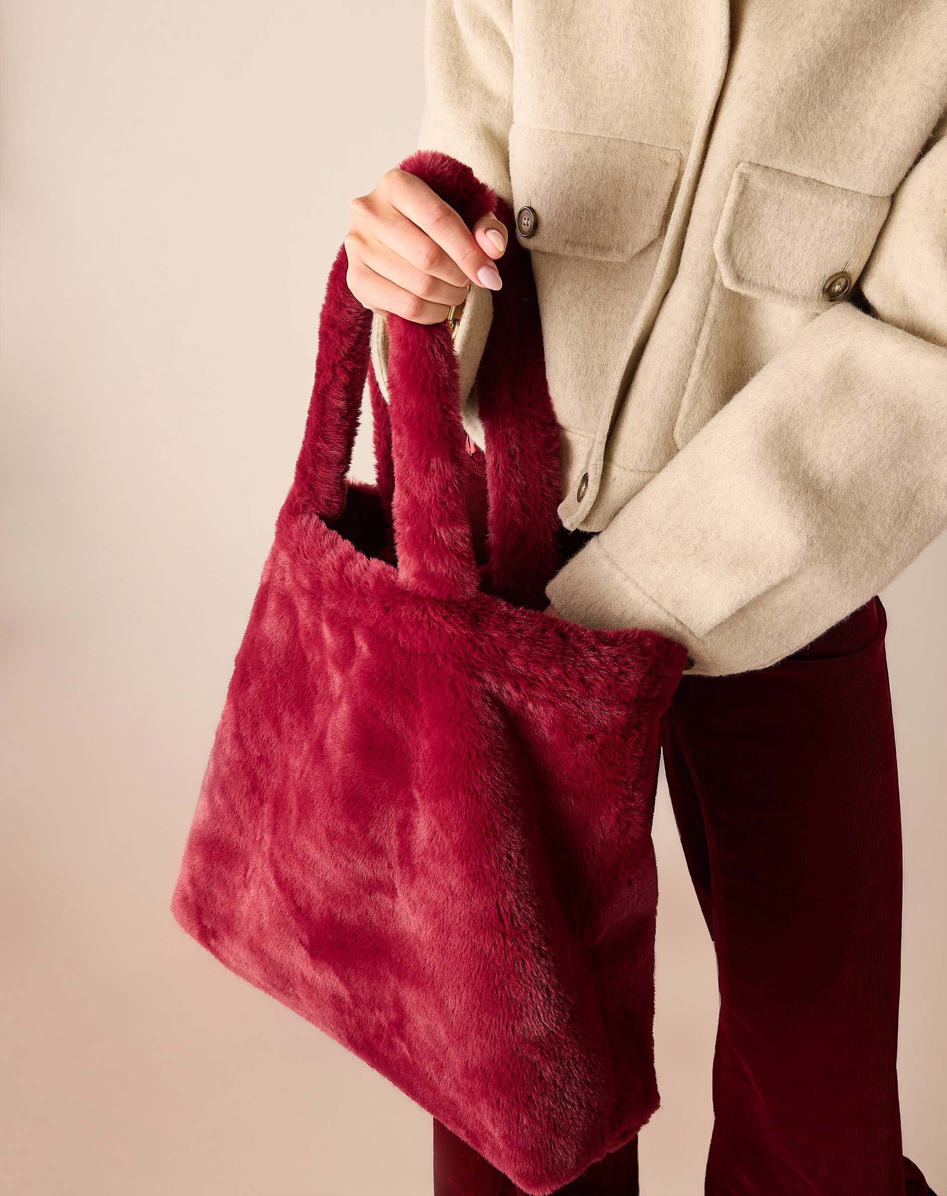 Women's travel-friendly garnet faux fur tote bag with plush handles