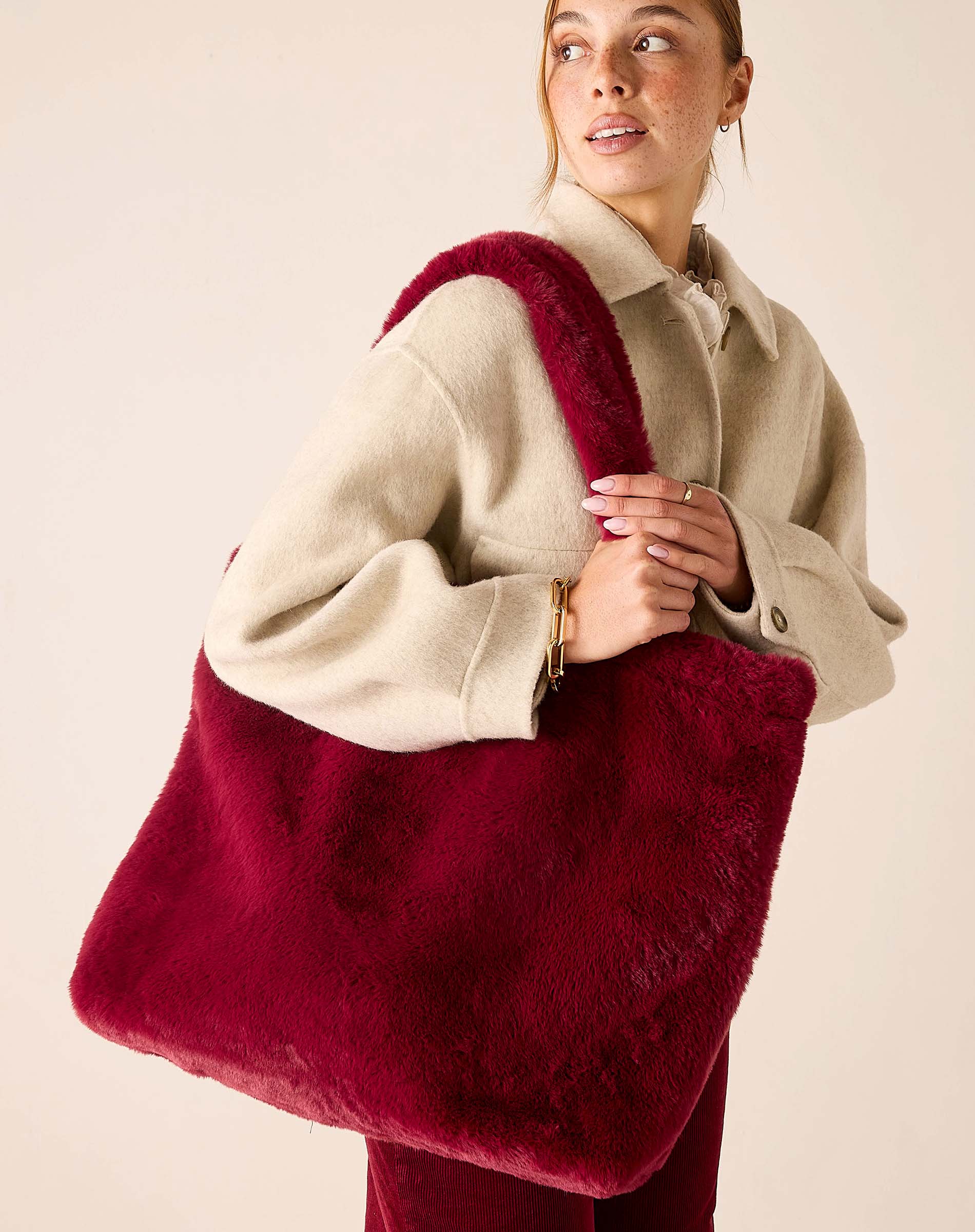 Garnet faux fur tote bag featuring a large oversized silhouette and plush material.