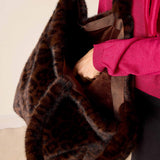 Brown leopard print faux fur tote bag with plush trim.