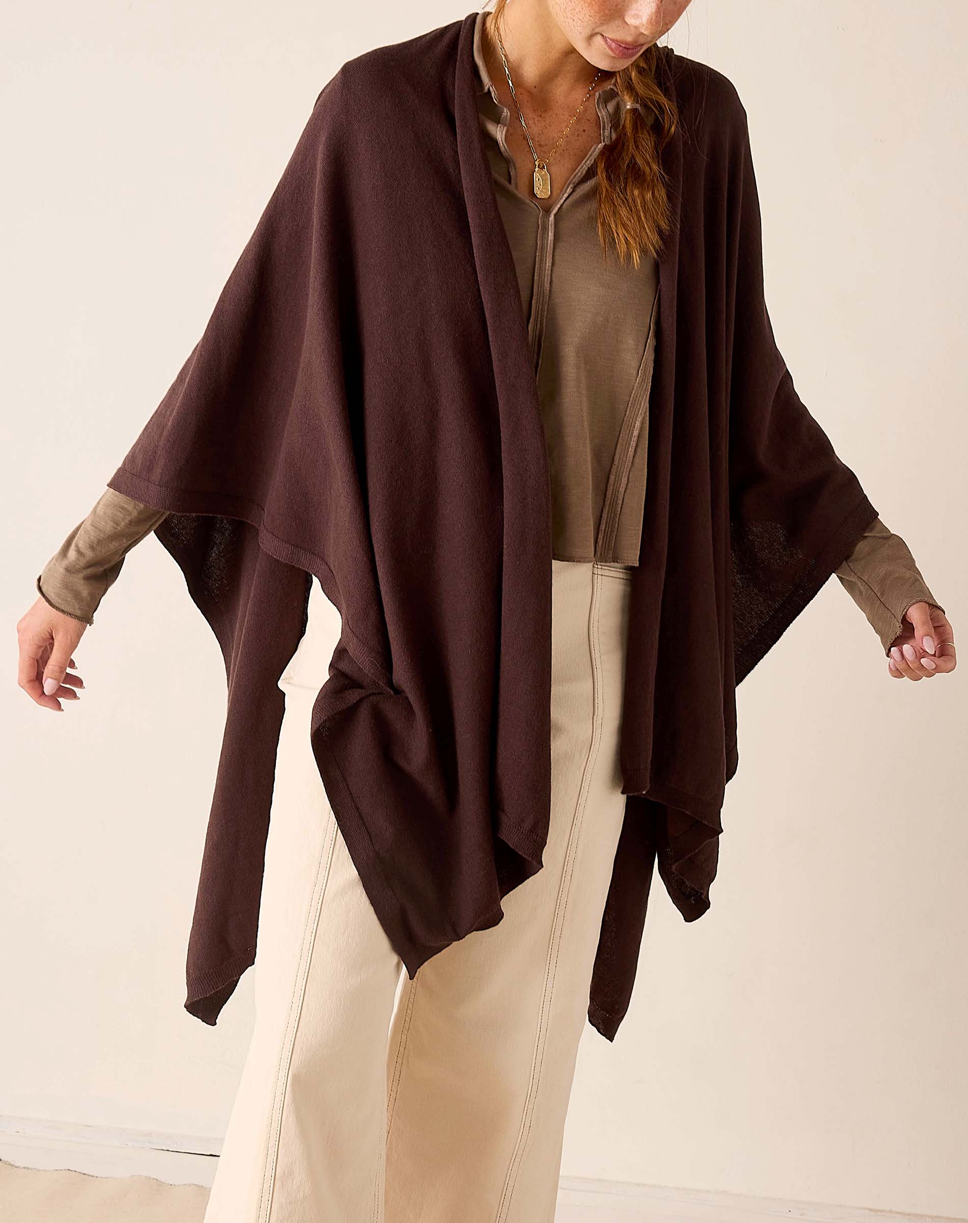 Chocolate brown draped travel wrap with long edges and soft knit texture.