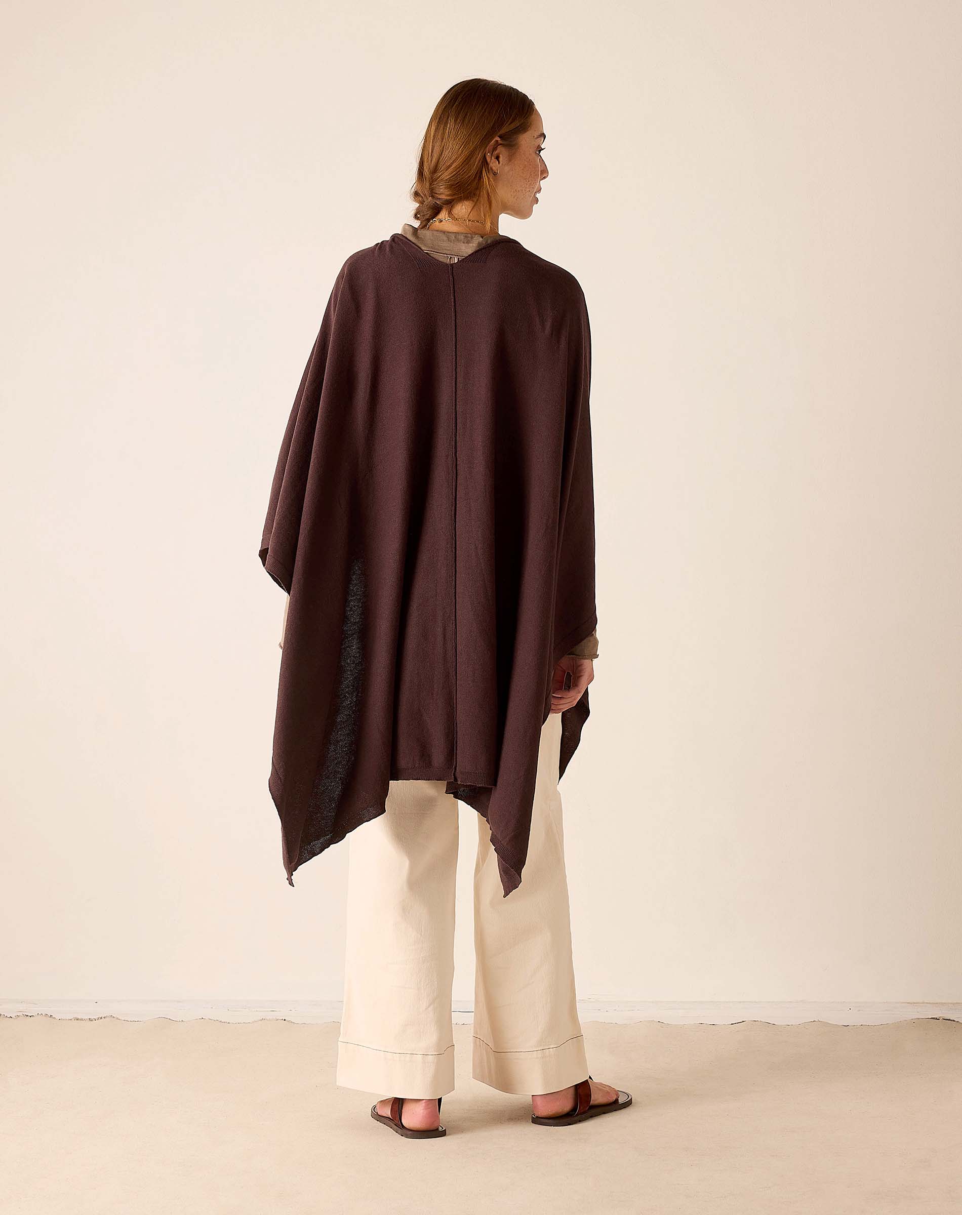 Back view of the chocolate wrap with a wide hem and draping fabric.