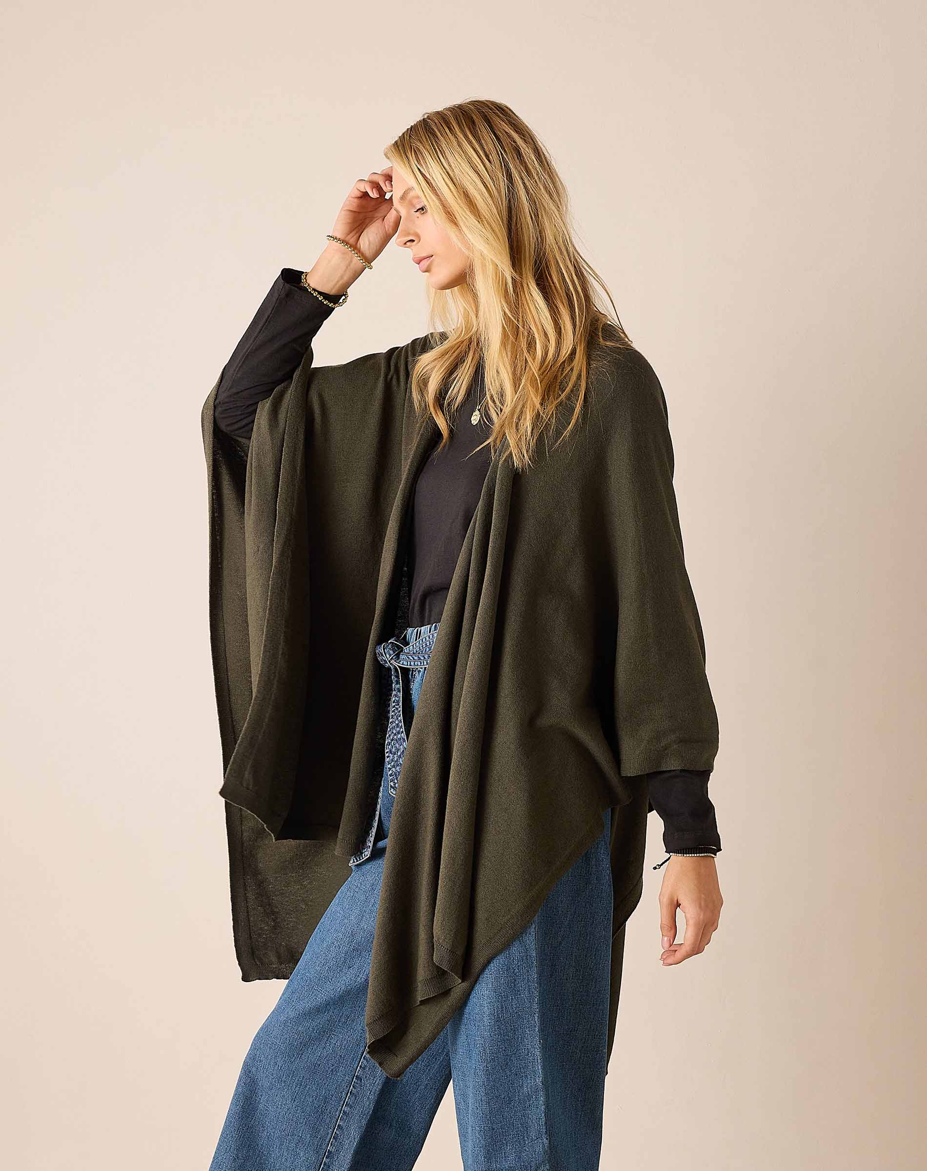 Olive wrap with longer back hem and open front for easy travel layering.