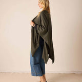 Side view of the olive green knit travel wrap.