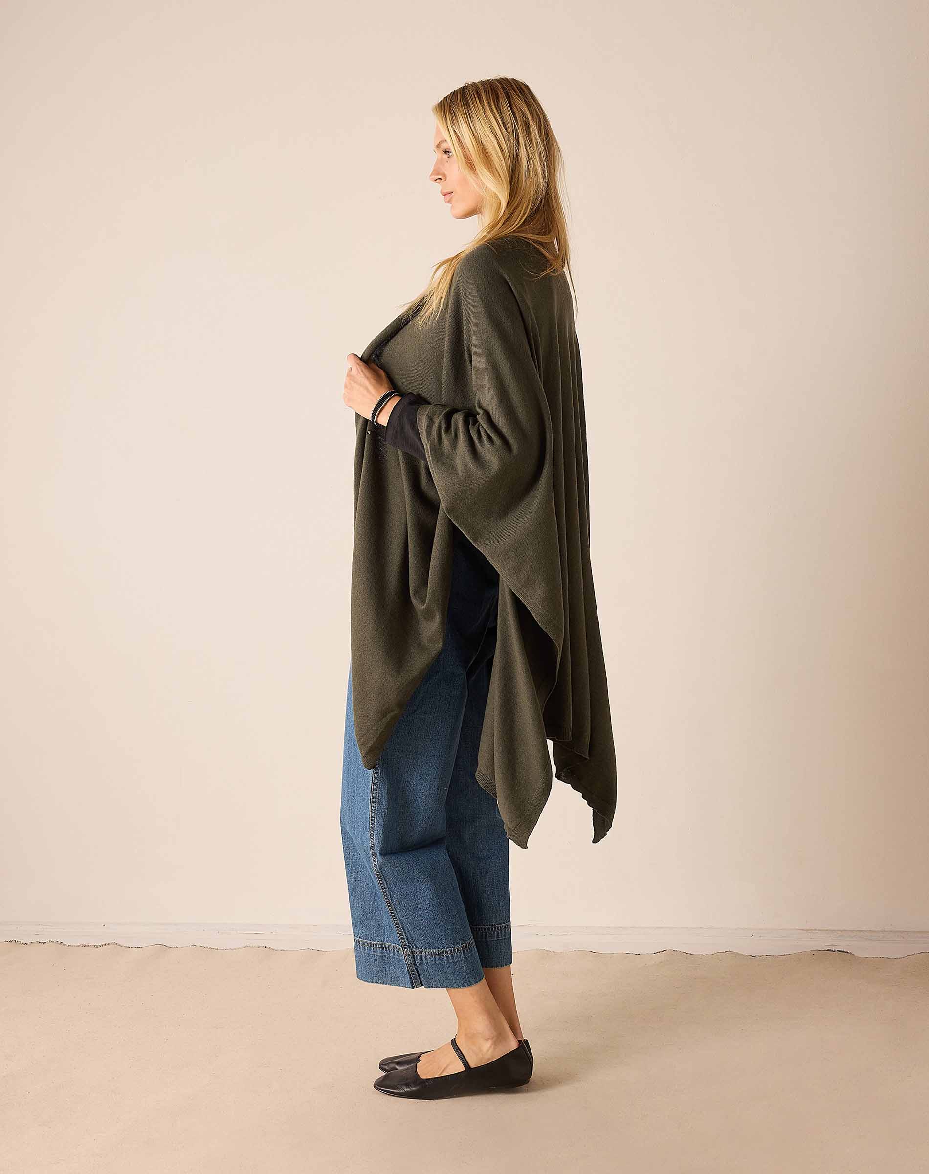Side view of the olive green knit travel wrap.