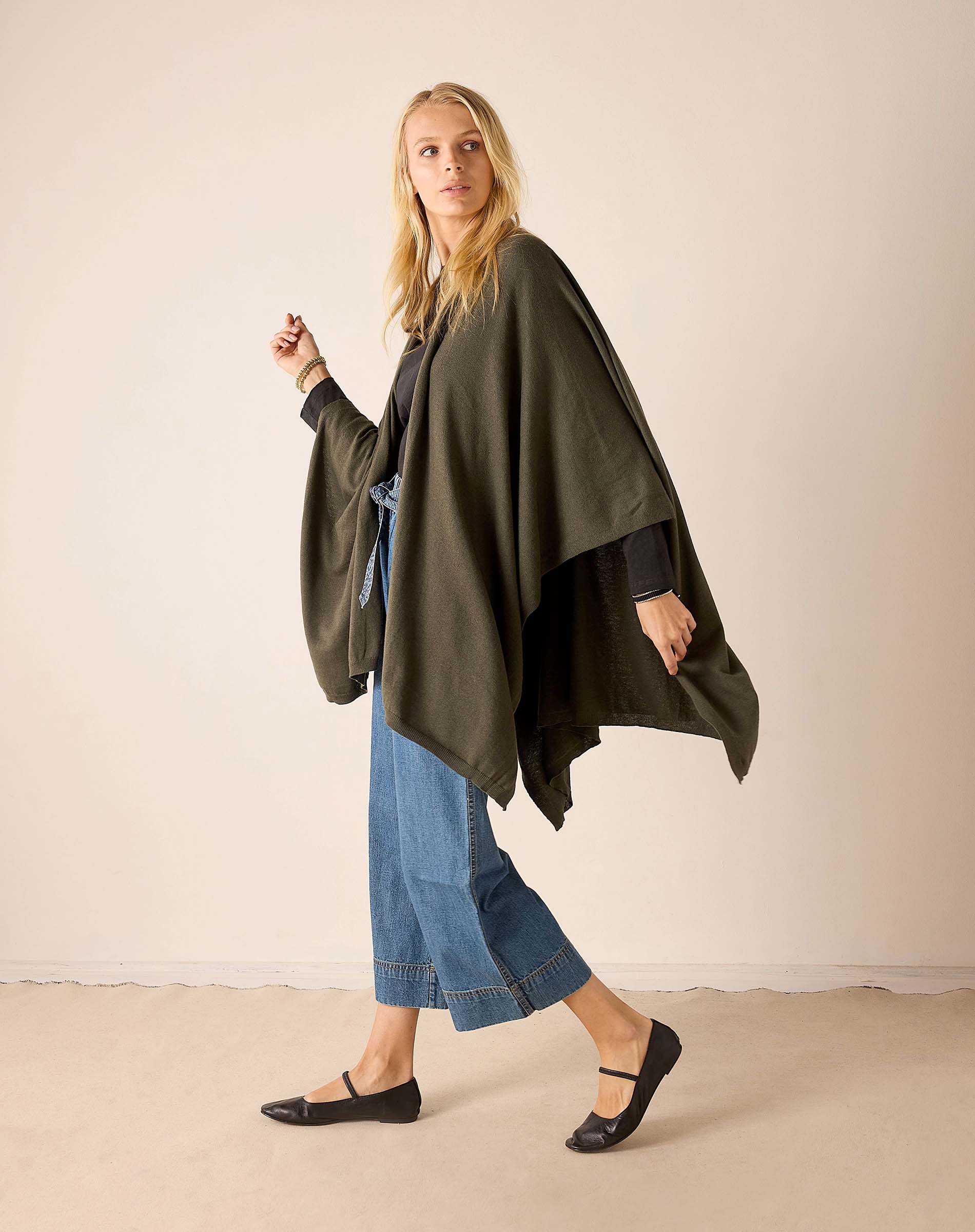 Olive green draped wrap in a soft knit fabric with open sides.
