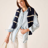 MERSEA ladies' travel-ready light blue button-up shirt paired with a navy and cream striped knit wrap.