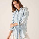 Light blue button-up shirt with a collar and long sleeves.
