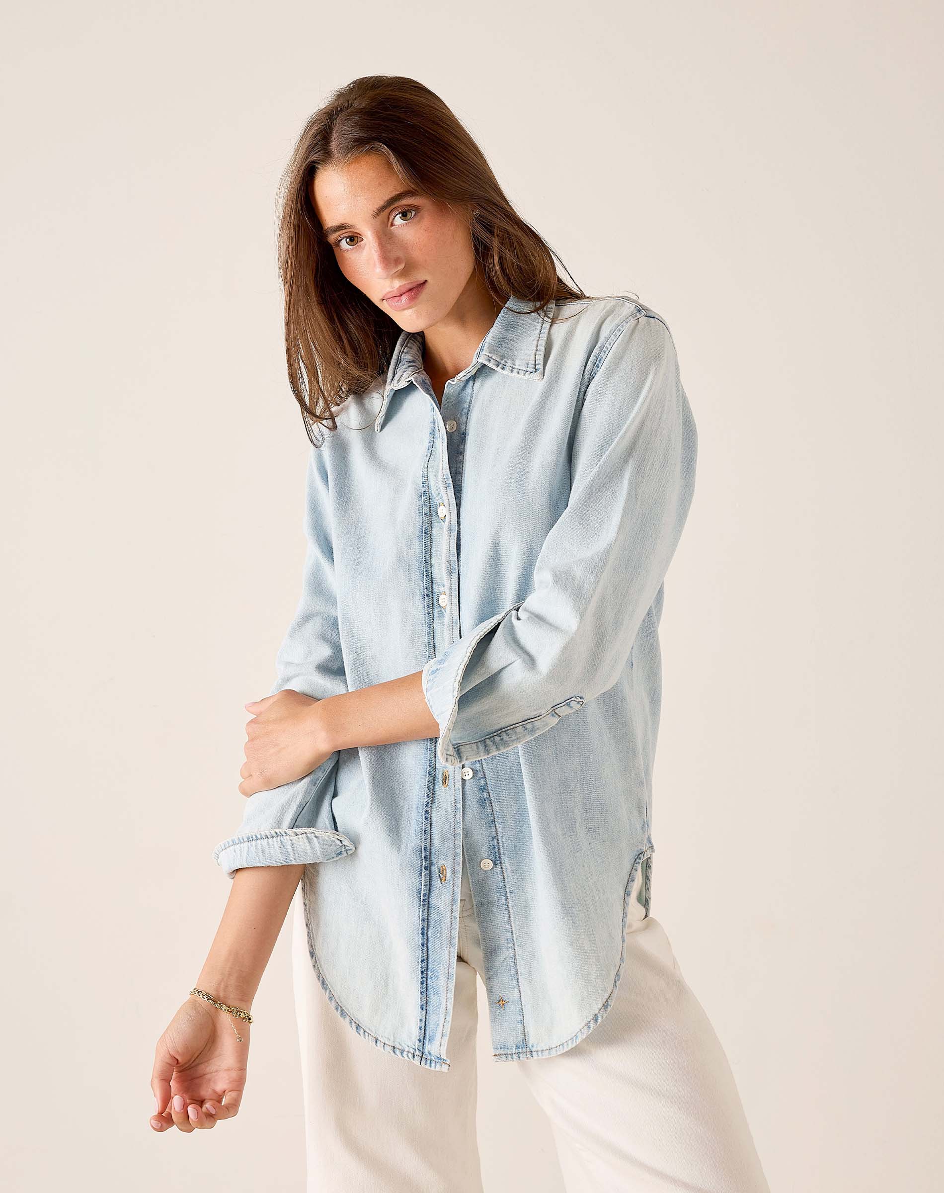 Light blue button-up shirt with a collar and long sleeves.