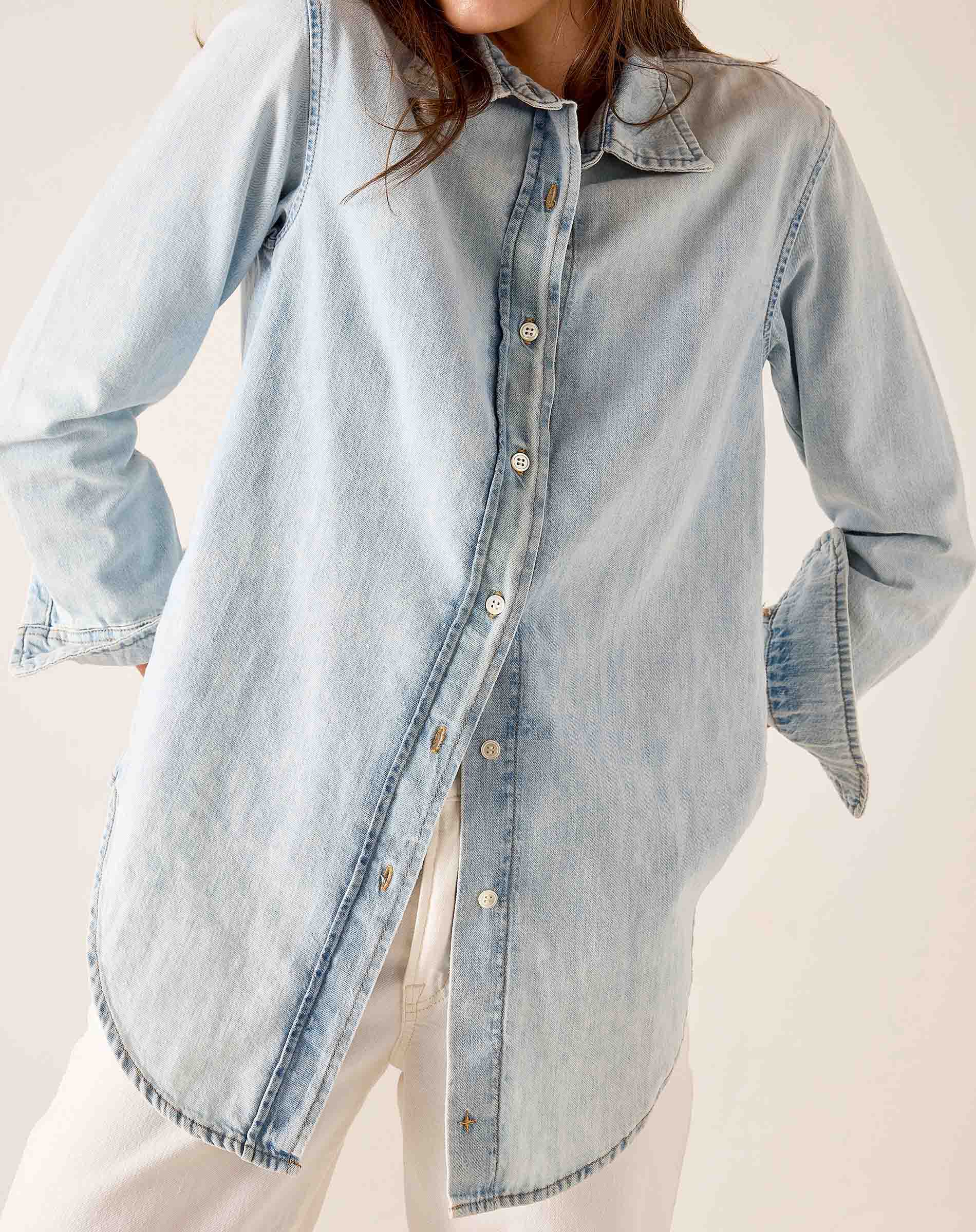 Light blue button-up shirt with a collar and long sleeves.