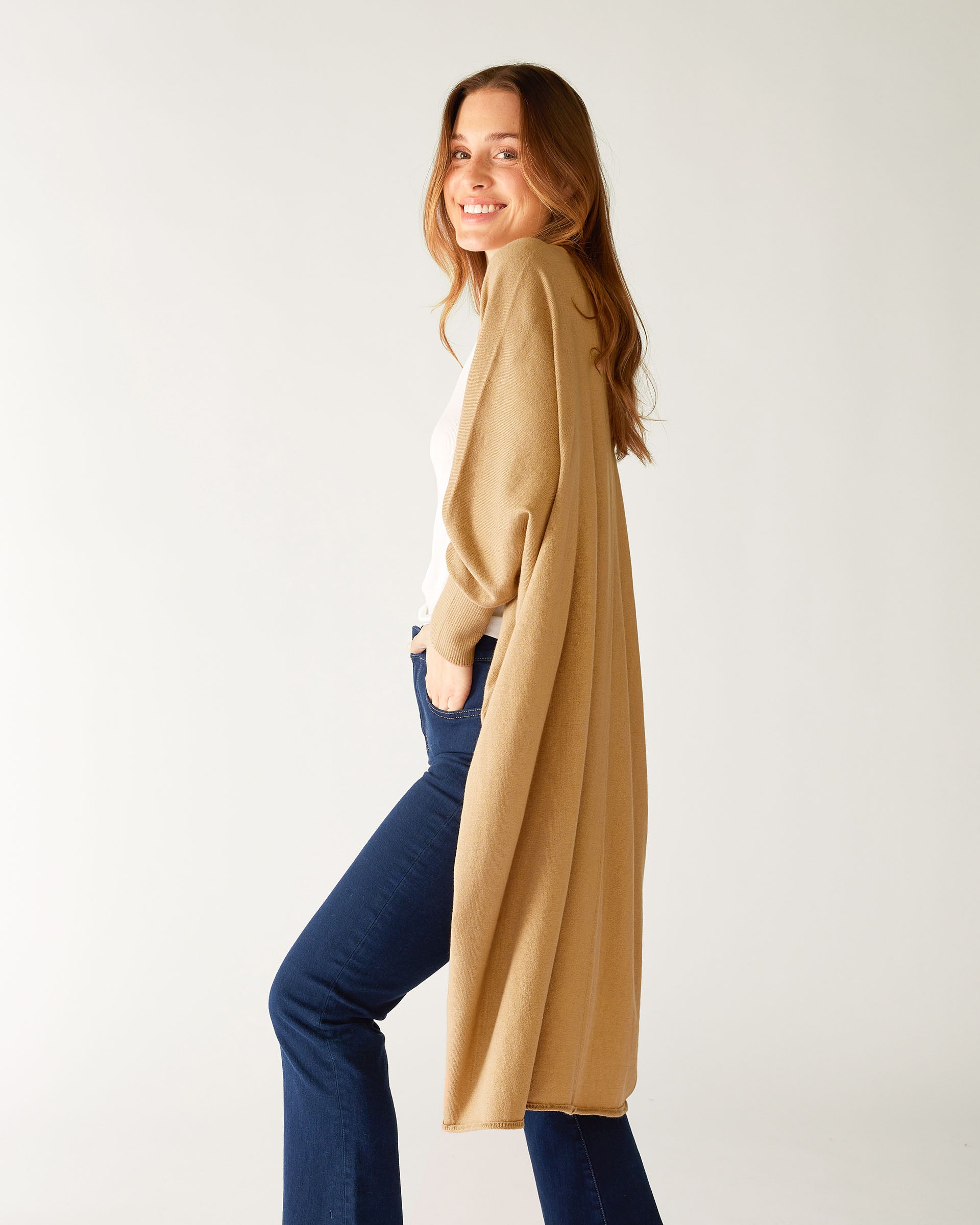 profile of woman wearing camel colored mersea long kimono sweater in cotton cashmere blend knit