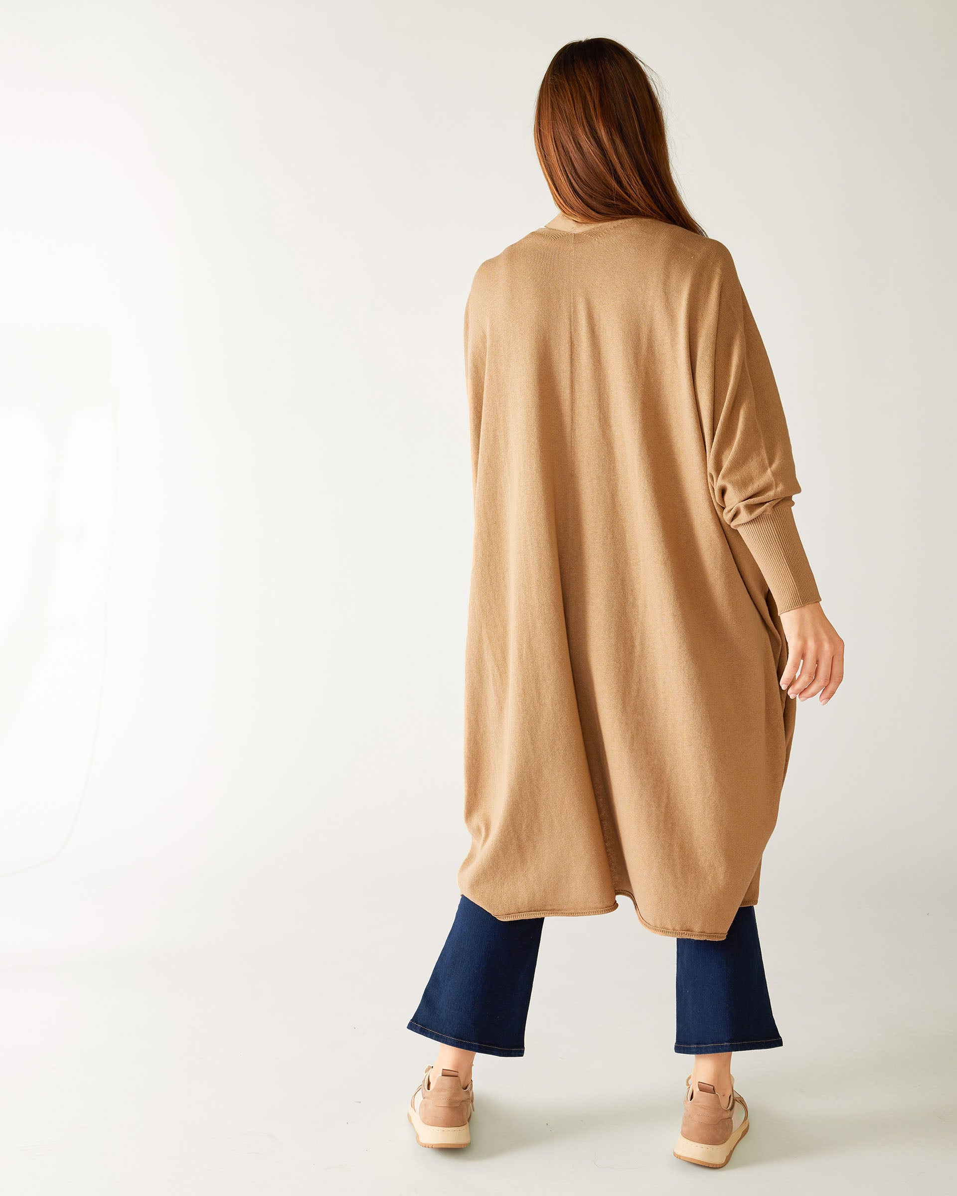 rear view of woman wearing camel colored mersea long kimono sweater in cotton cashmere blend knit