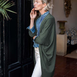 Olive green kimono wrap in a knit texture with wide sleeves and long side panels.