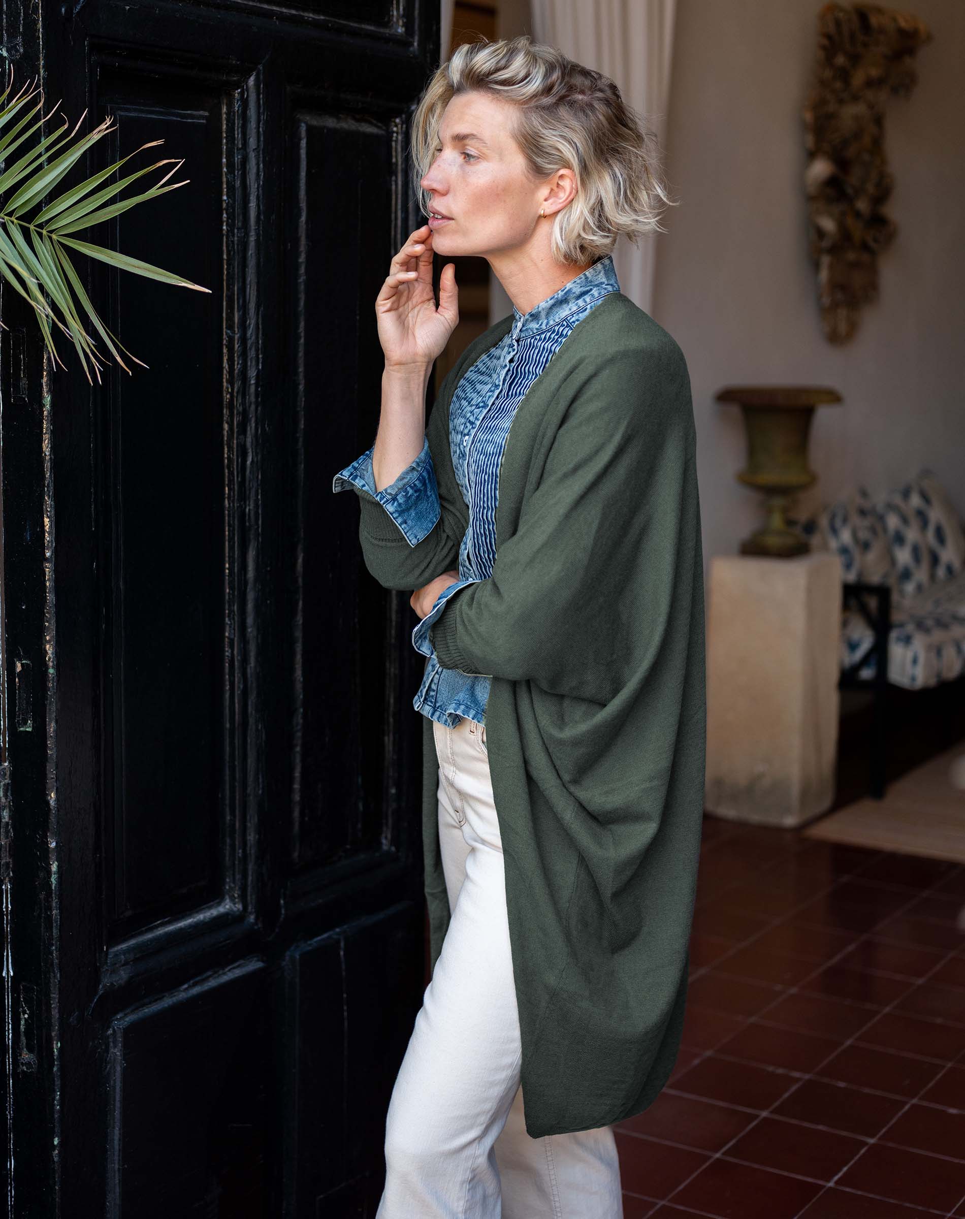Olive green kimono wrap in a knit texture with wide sleeves and long side panels.