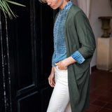 Side view of the olive green kimono wrap featuring a relaxed fit and long sleeves.