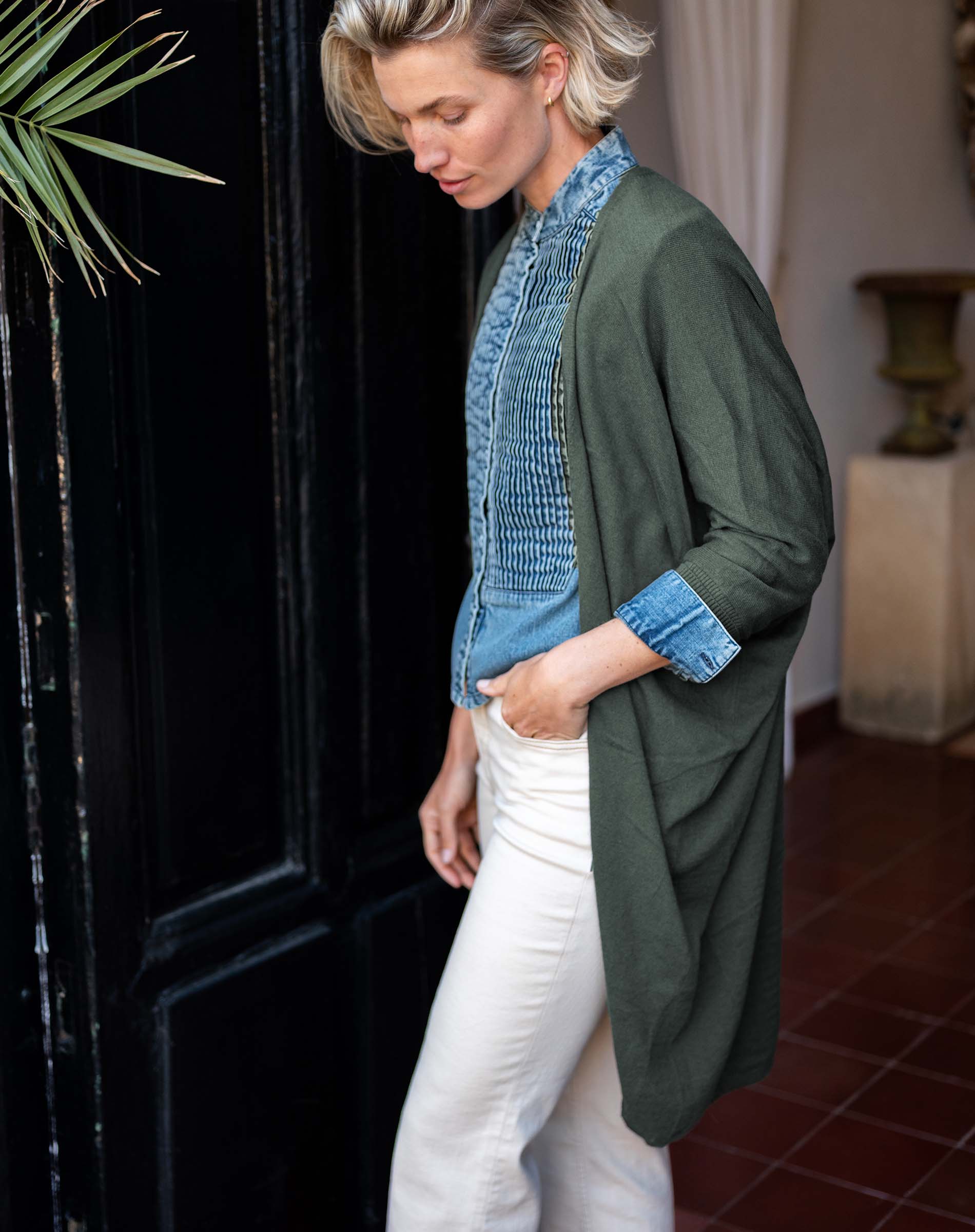 Side view of the olive green kimono wrap featuring a relaxed fit and long sleeves.