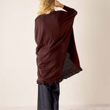 Back view of the chocolate ruffle kimono wrap with a gathered hem and loose fit.