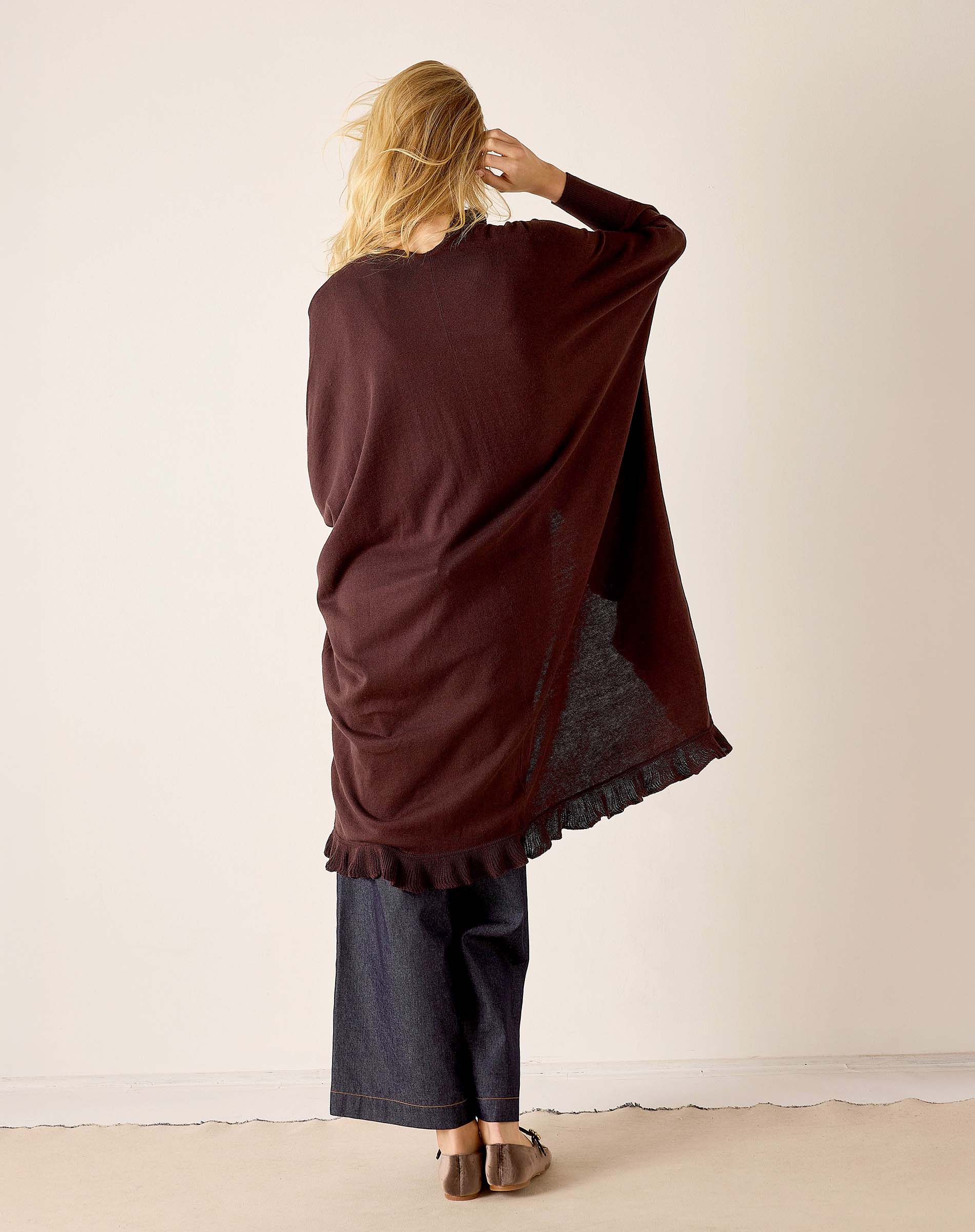 Back view of the chocolate ruffle kimono wrap with a gathered hem and loose fit.