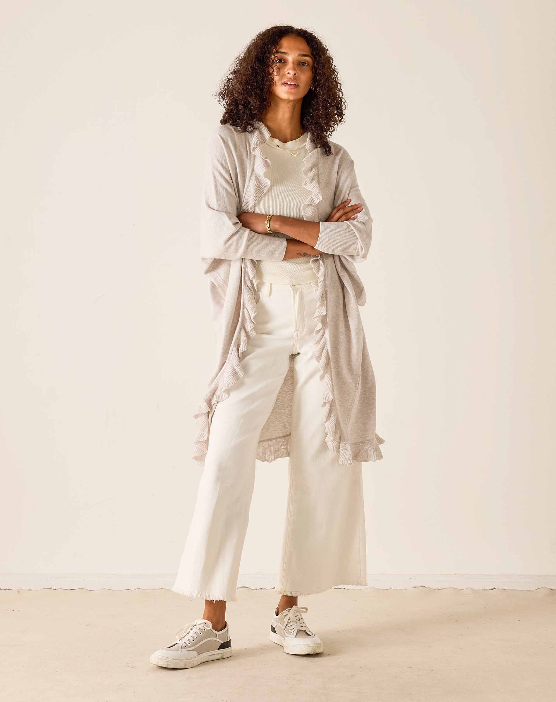 Woman wearing a beige outfit with a white background