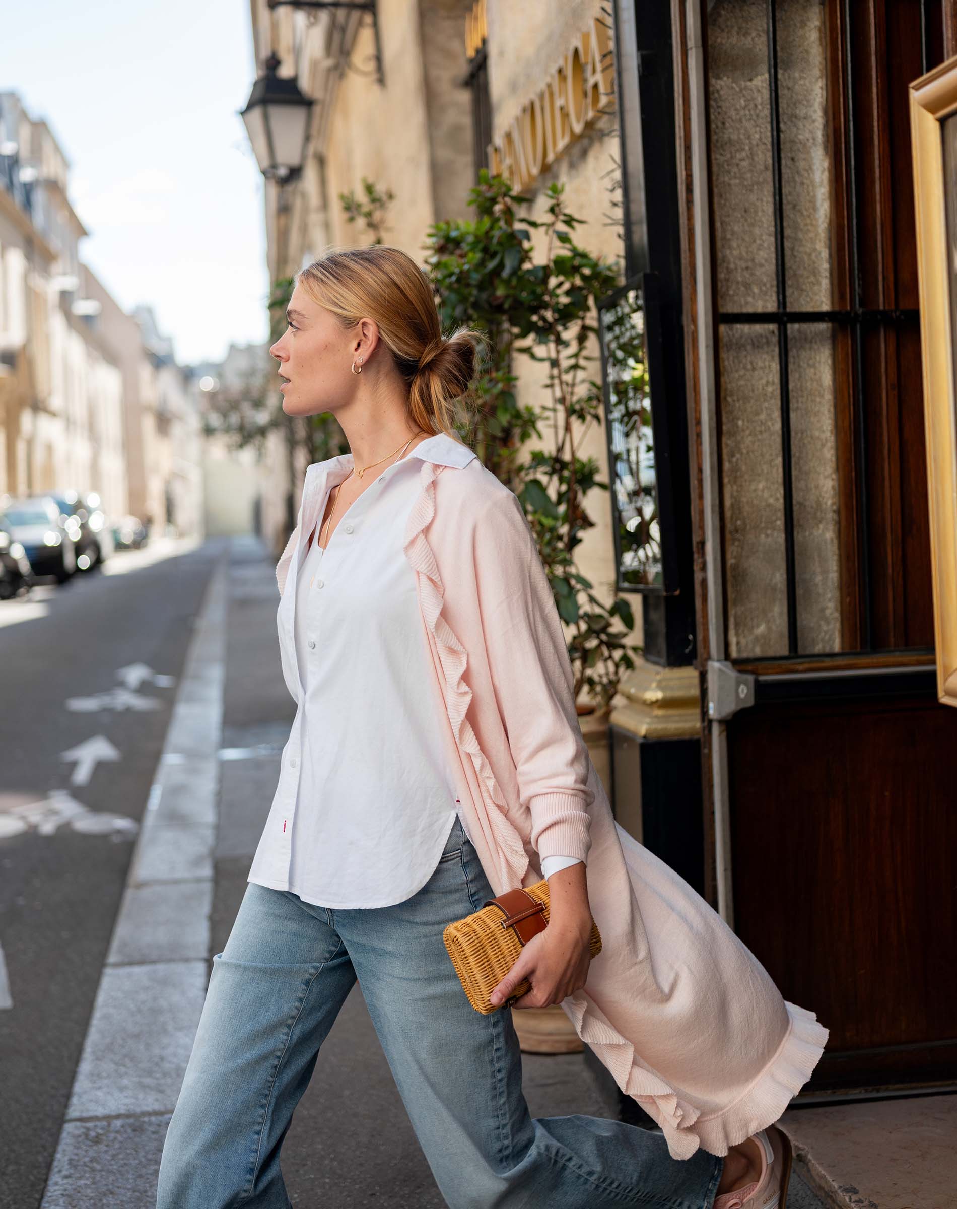 Woman walking down a street in an urban setting
