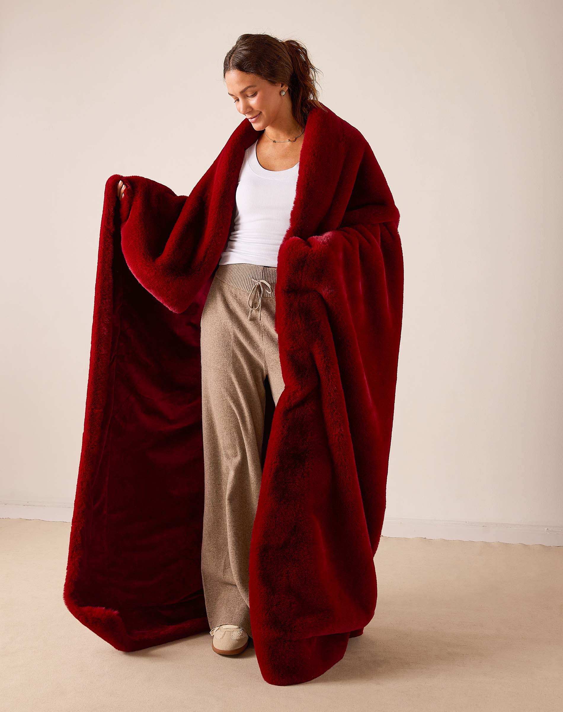 Garnet color oversized faux fur throw with soft plush finish.