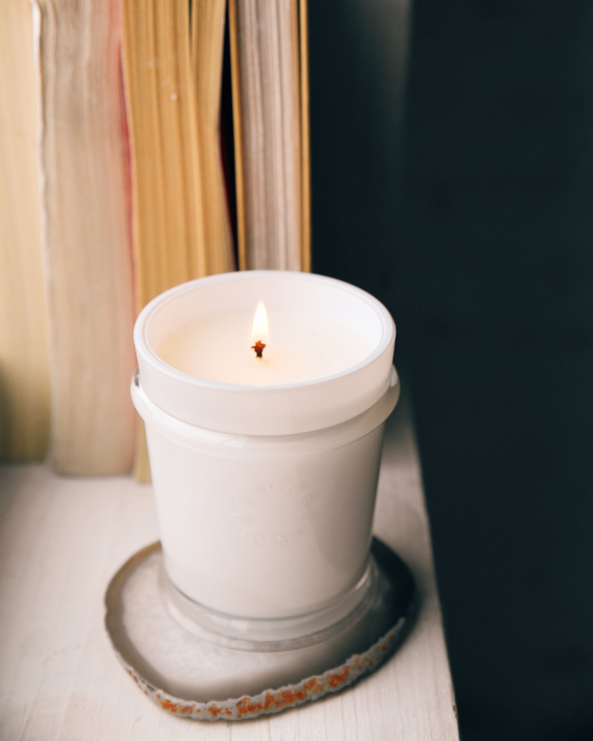 lit cabana flower candle on coaster