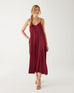 woman wearing mersea coco satin jumpsuit in garnet against white backdrop