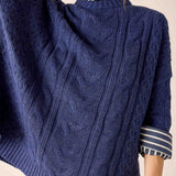 Women's travel-friendly dusk blue cableknit knit sweater with a textured weave.