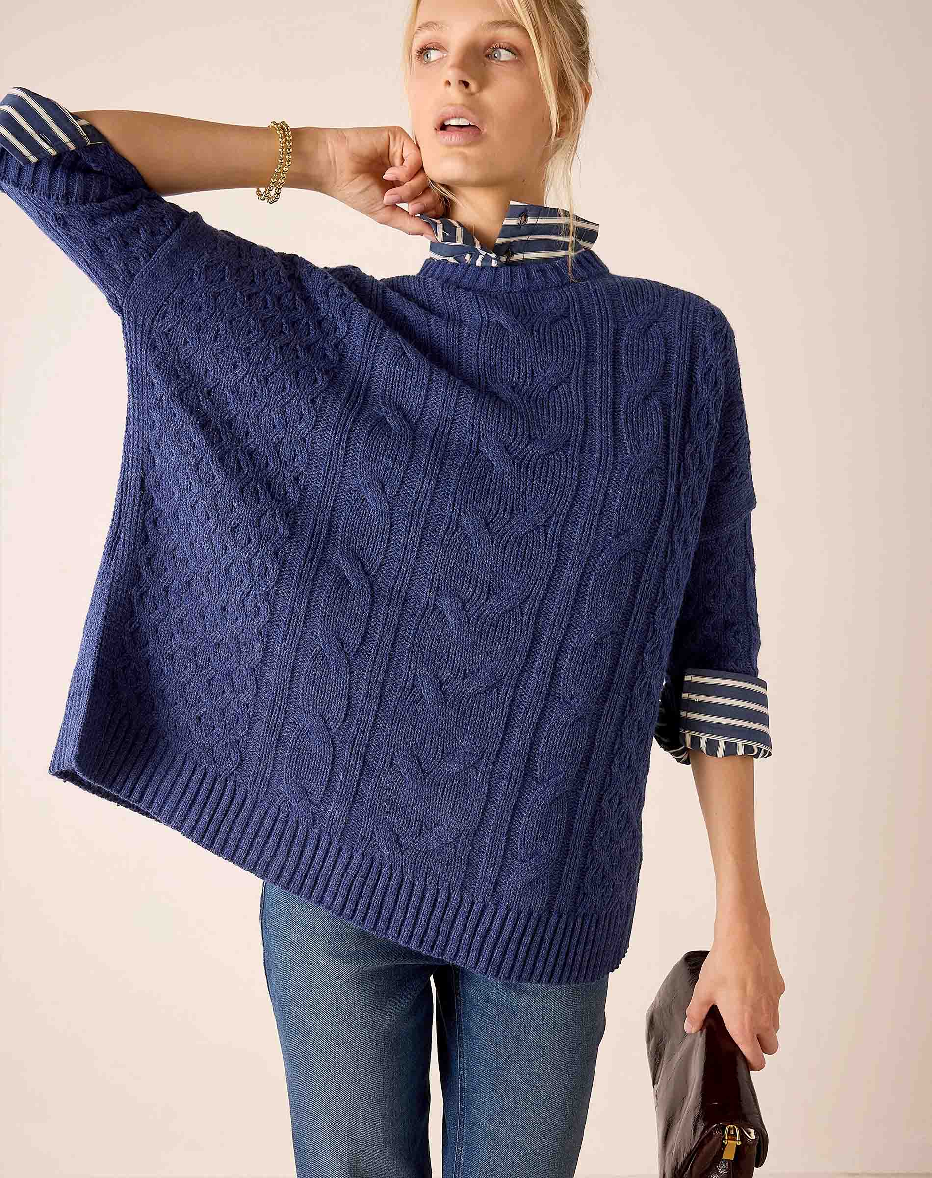 Dusk blue cable knit sweater with wide striped cuffs.