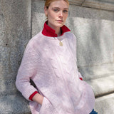 Women's travel-friendly petal pink cable knit sweater with a textured weave and full-length sleeves.
