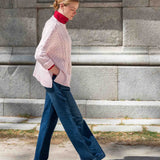 Petal pink cableknit sweater with a textured knit finish.