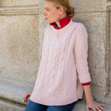 Petal pink cableknit sweater with a textured knit pattern and drop shoulder detail.