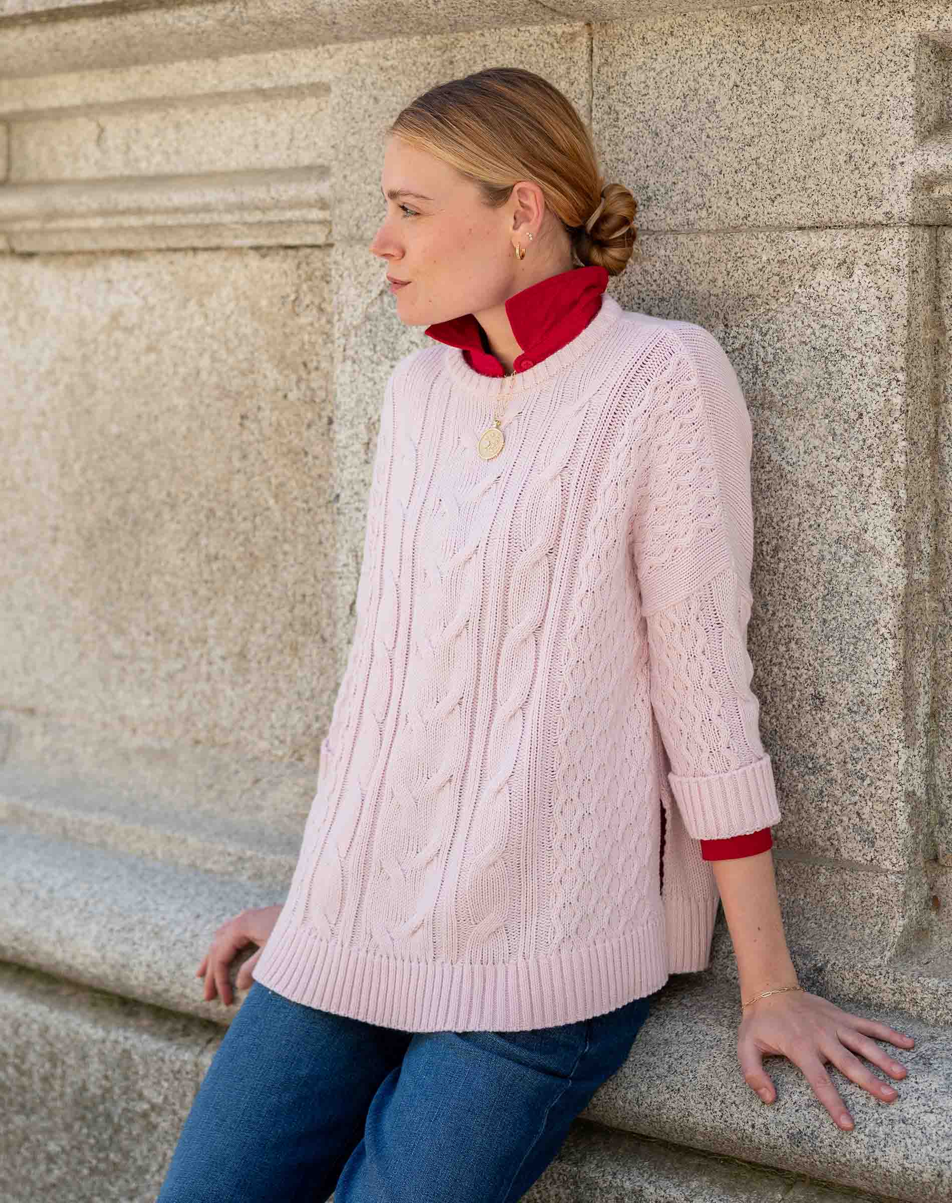 Petal pink cableknit sweater with a textured knit pattern and drop shoulder detail.