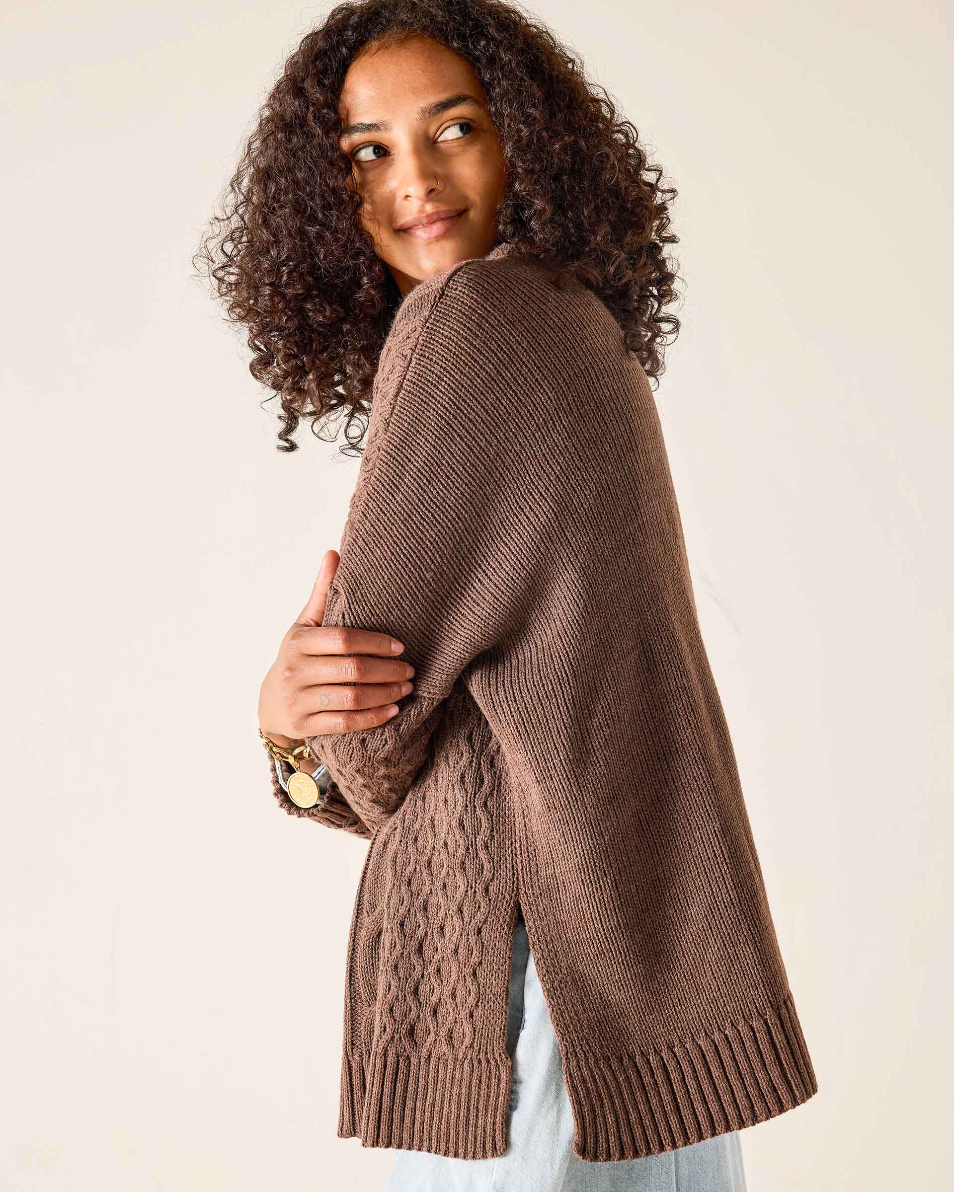 Brown ribbed knit cotswold sweater with cable knit detailing.