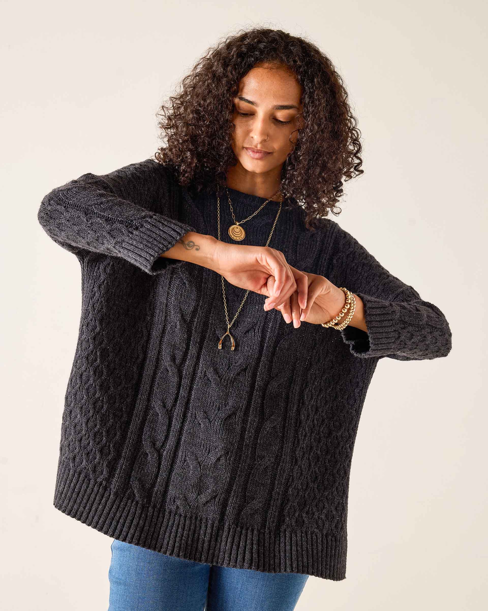 Charcoal cable knit sweater with ribbed cuffs and hem.