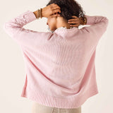 Light pink ribbed knit sweater with dropped shoulders and a wide ribbed hem.