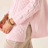 Light pink cable knit sweater with ribbed cuffs and hem.