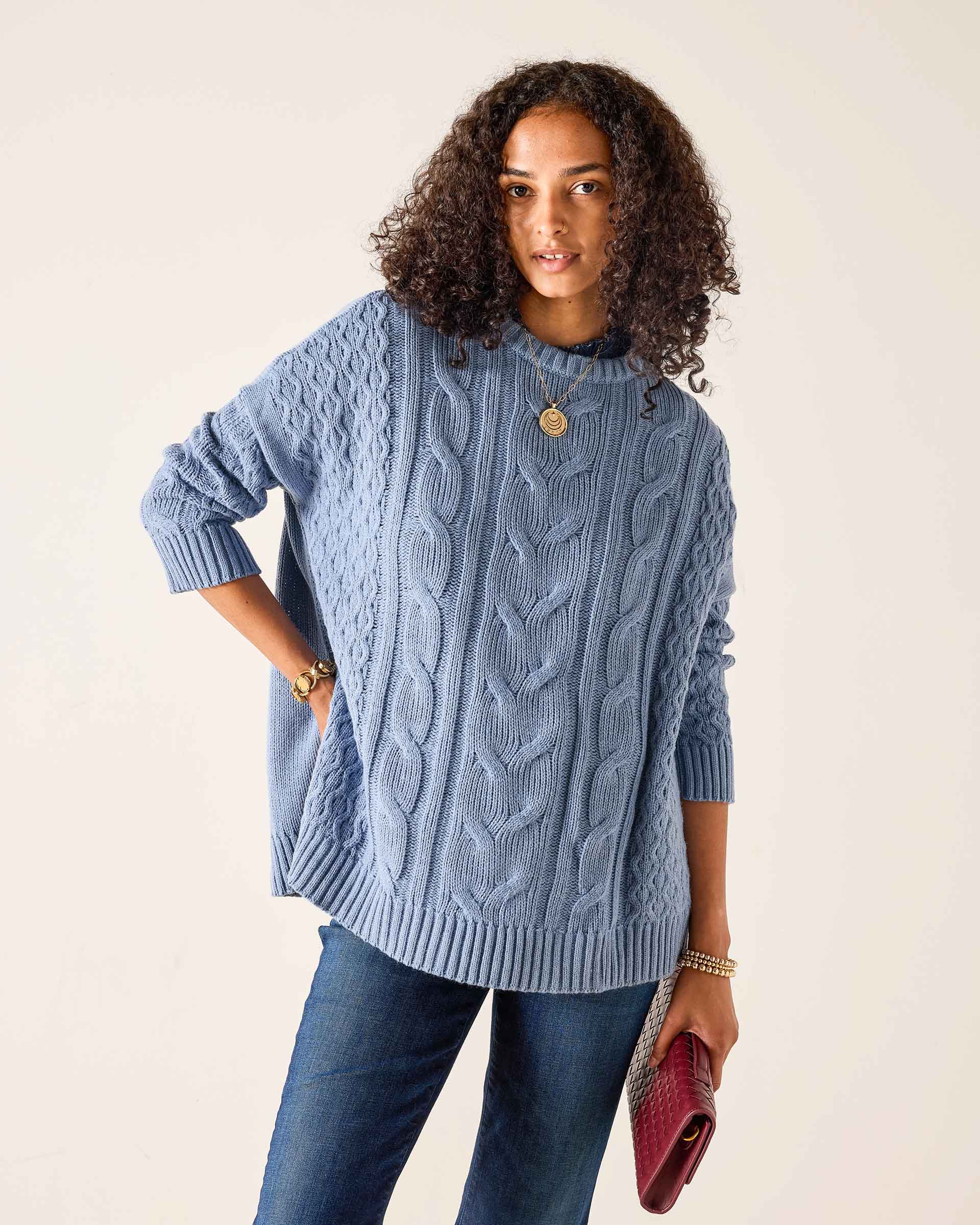 Ladies' travel-ready misty blue oversized cable knit sweater.