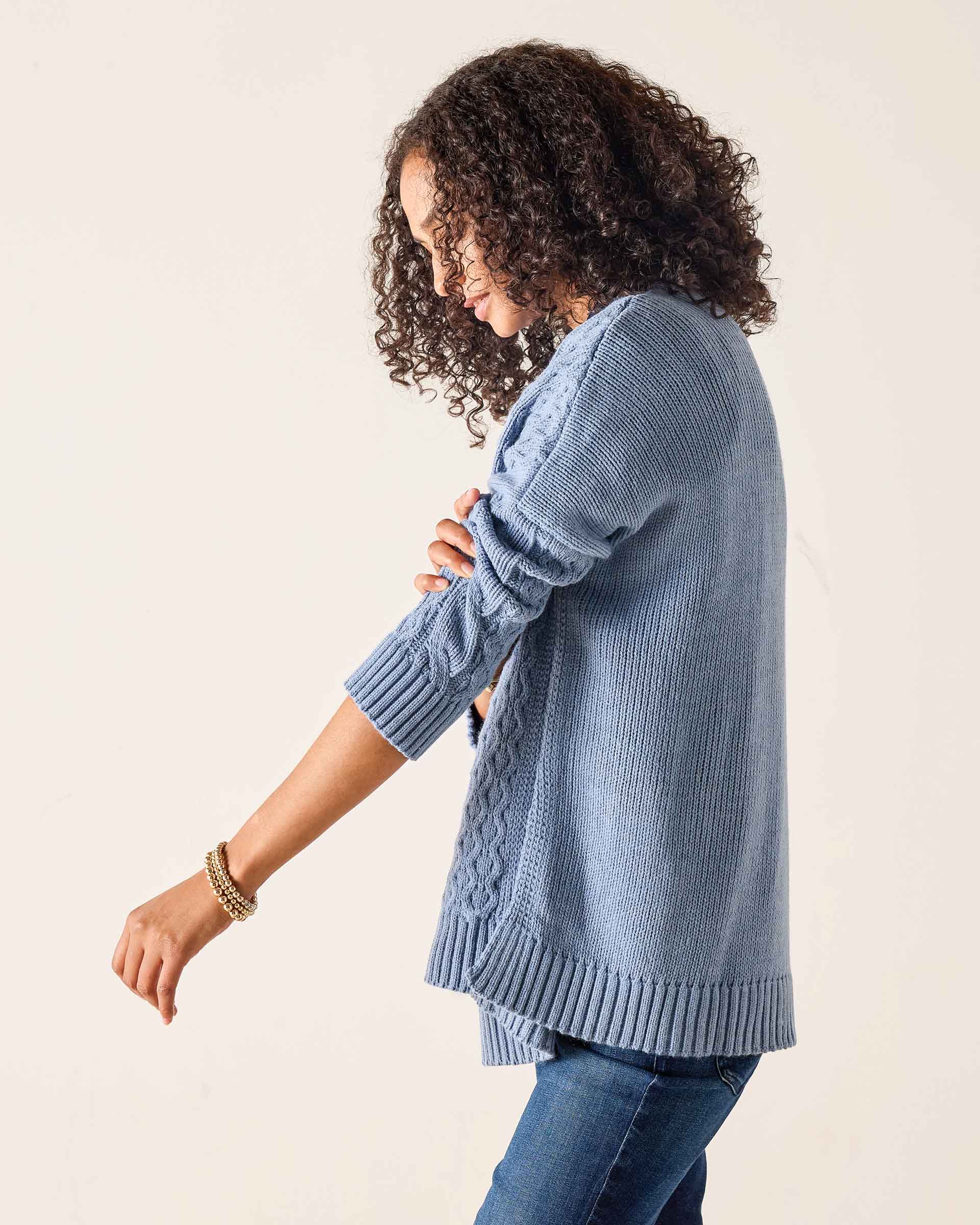 Misty blue ribbed knit sweater with textured paneling and wide ribbed cuffs.