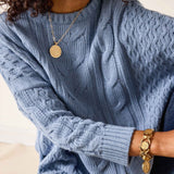 Misty blue cable knit sweater with a ribbed hem and cuffs.