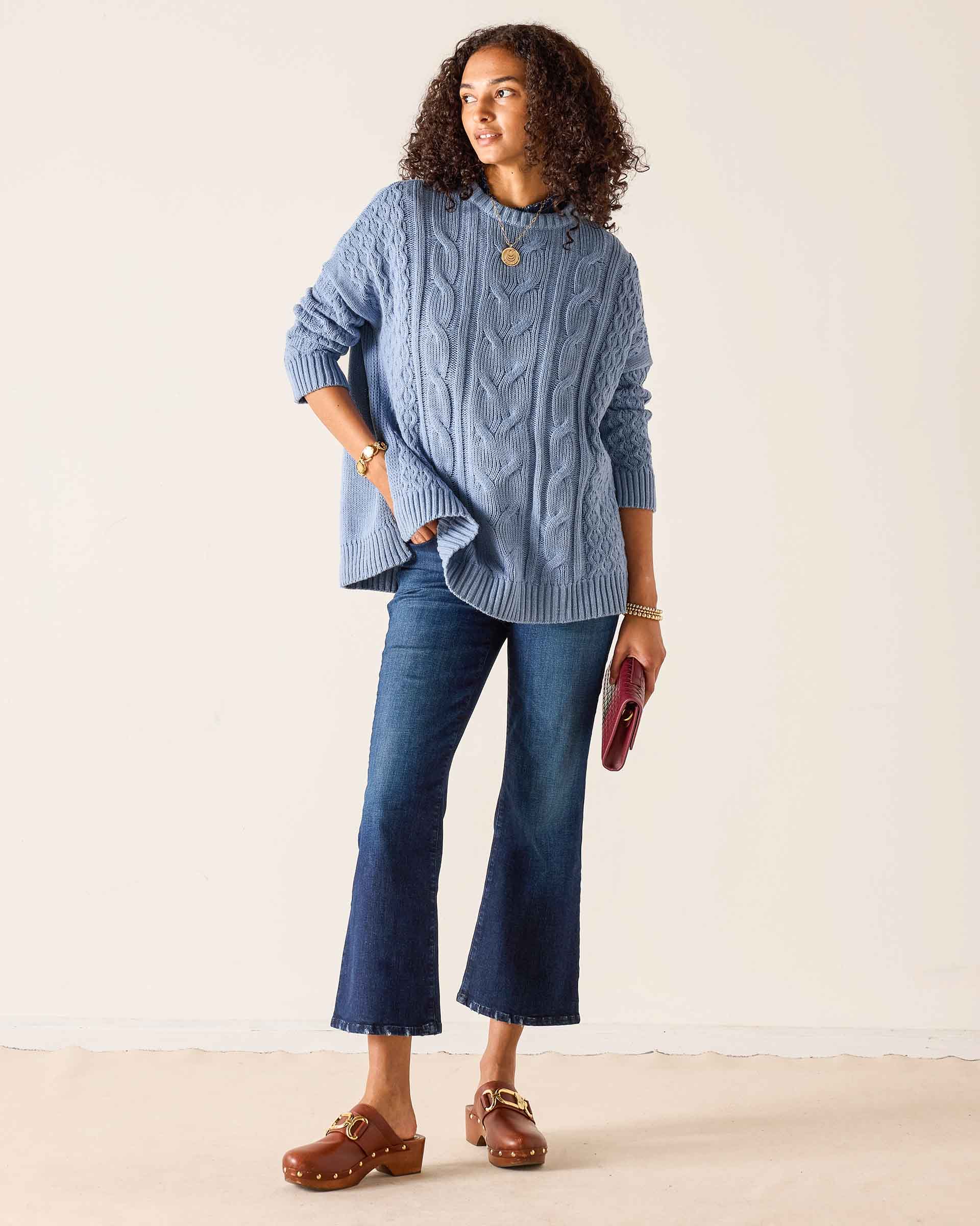 Misty blue cable knit sweater with a relaxed fit and ribbed hem.