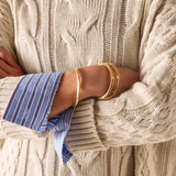 Sea salt cream cable knit sweater with oversized cuff detail.