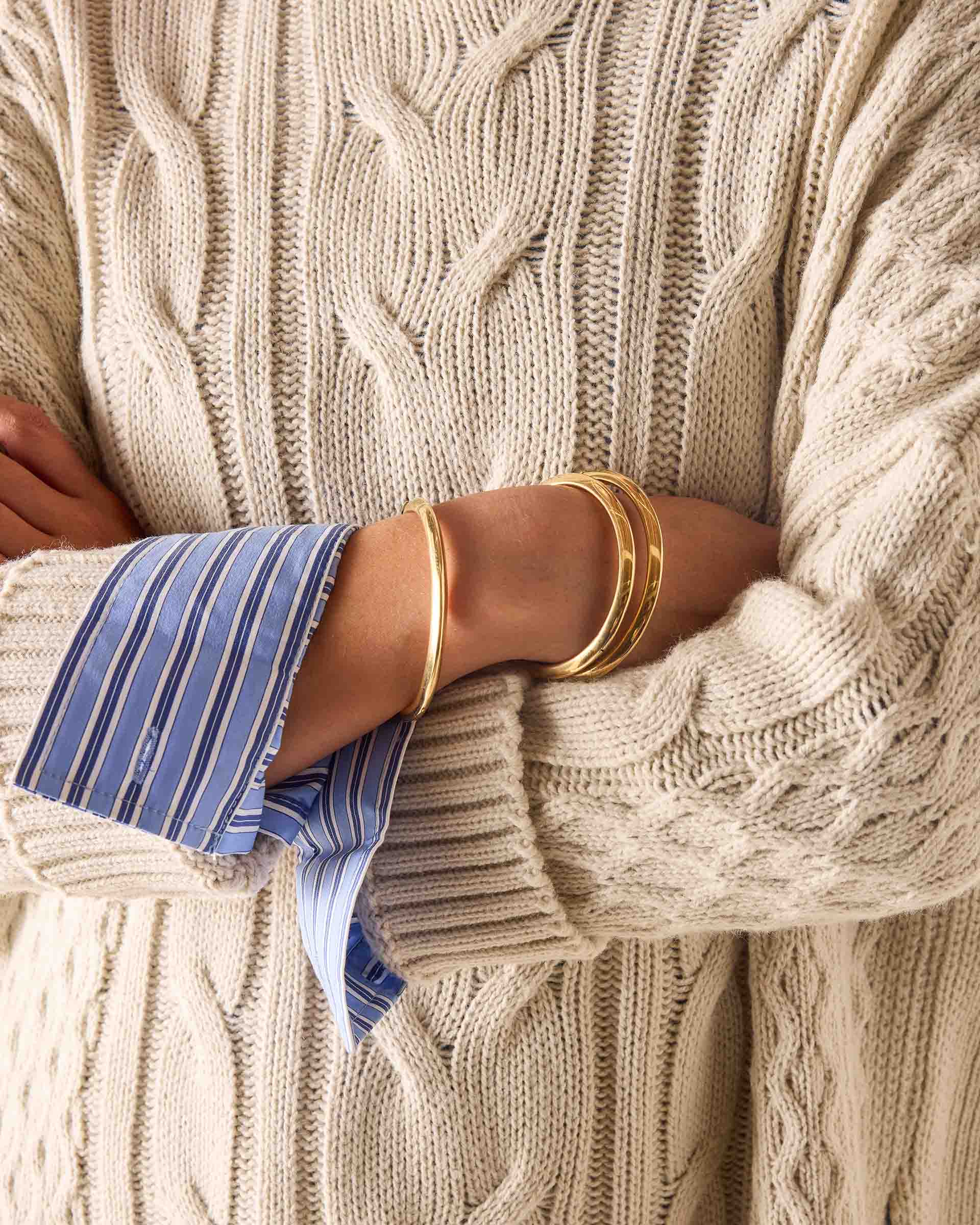 Sea salt cream cable knit sweater with oversized cuff detail.